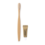 Escova de dentes de bambu e pasta dentífrica em caixa de cartão cor natural primeira vista