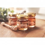 Frascos de mel e colher de mel em madeira cor madeira vista conjunto principal